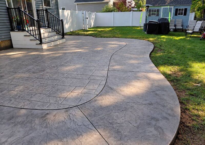 Curved stamped patio two patterns ashlar seamless black railings