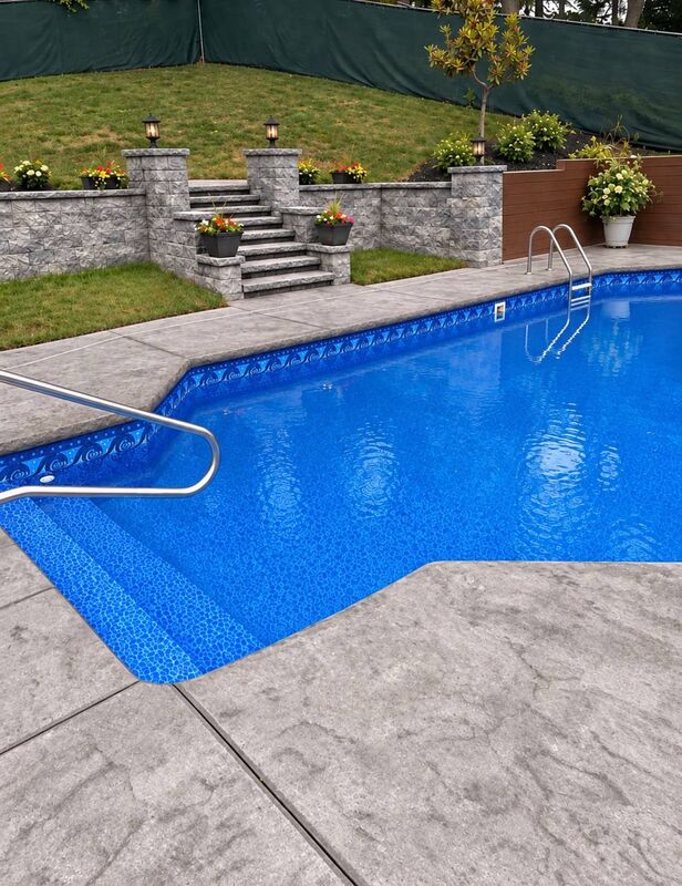 Gray seamless stamped pool deck block retaining wall steps lanterns