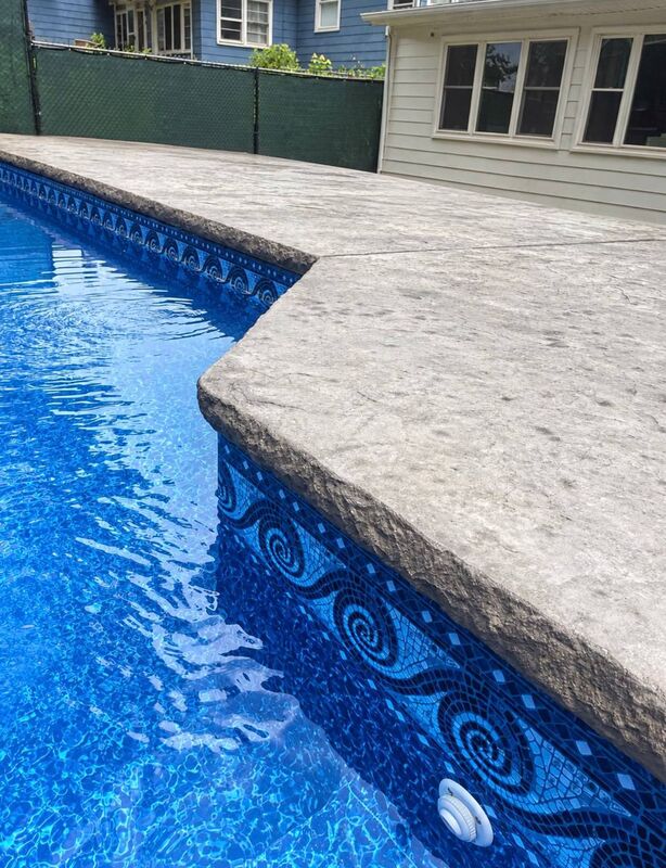 Gray stamped pool deck mosaic liner chain link privacy screen