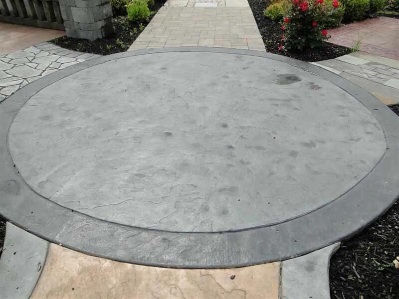 Circular stamped concrete medallion with paver borders