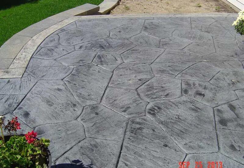 Charcoal flagstone stamped patio with light border