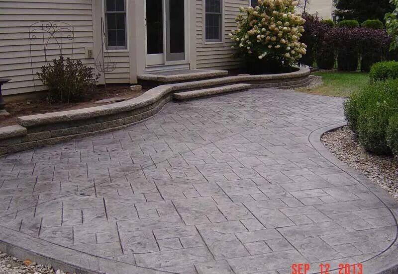 Gray ashlar stamped patio with block seat wall and steps