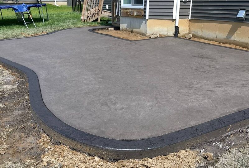 Smooth patio dark stamped border fresh pour