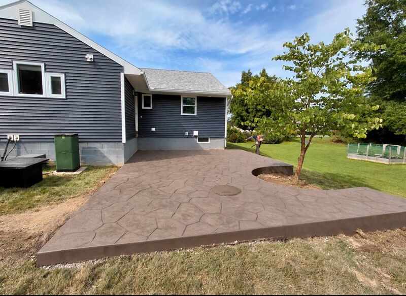 Random flagstone stamped patio tree cutout navy house wide